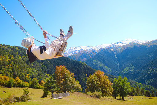 Hiker Enjoy the Swing with Amazing Early Autumn View of the Caucasus Mountains