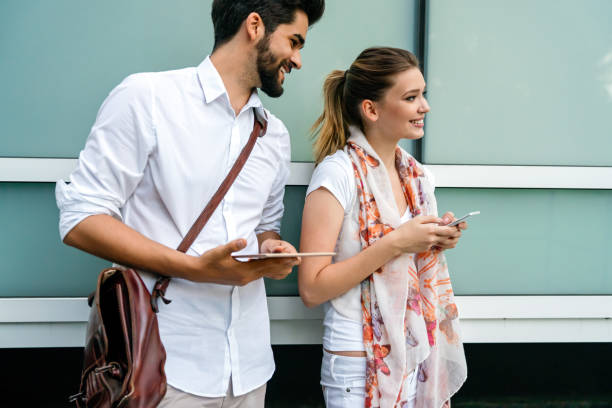 istock Happy business people outdoors with digital devices. Business technology smartphone, tablet concept 1478003147