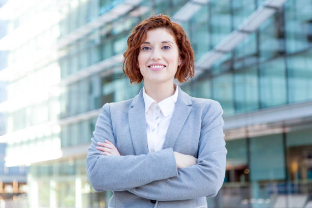 istock Successful young female executive posing confidently with crossed arms in office zone. 1478004170