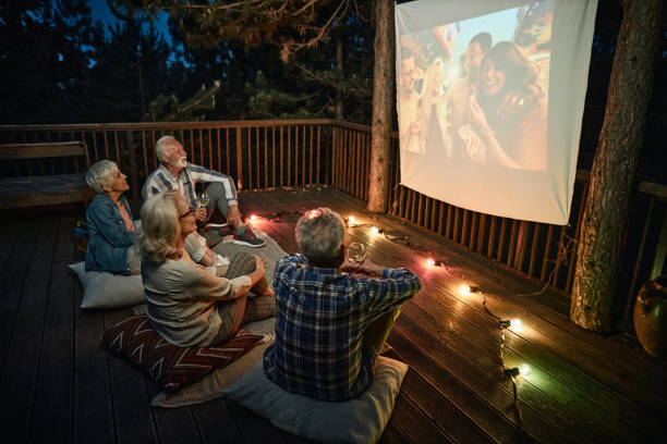 istock Mature couples relaxing during movie night on a terrace. 1478005719