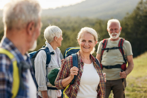 istock Happy senior friends talking while hiking in nature. 1478005866