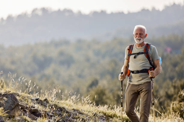 istock Happy senior man hiking in spring day on a hill. 1478006265