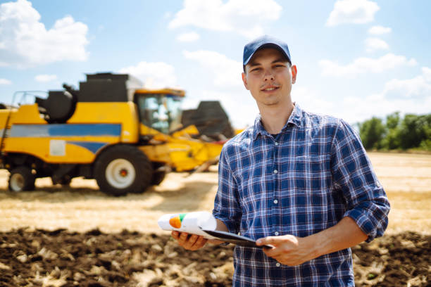 istock Farmer holds a tablet with a yield map for a combine in a wheat field. 1478007502