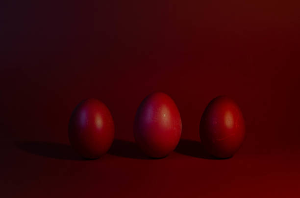 istock Eggs painted in red color on a rustic background. Happy Easter. 1478009224