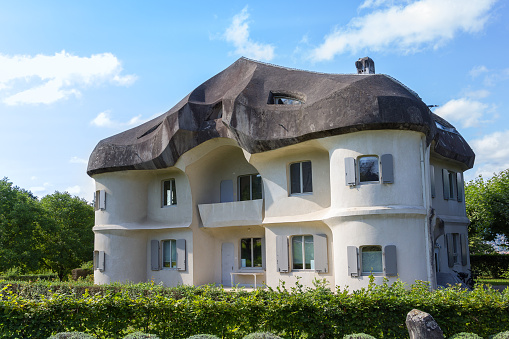 Dornach, Switzerland - August 24. 2021: A house at the side of the Goetheanum II, in the same Expressionistic architecture style. This place is the world center for the anthroposophical movement.