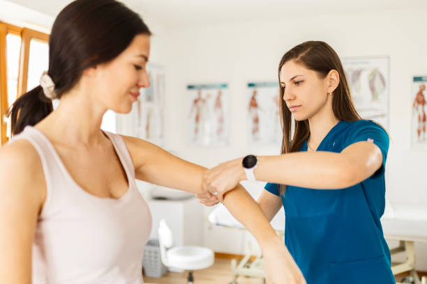 istock Physical therapy ,female patient with chiropractor with elbow pain 1478018423