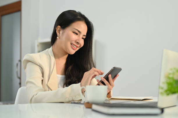 istock Attractive asian female financial advisor chatting with client online, giving internet consultation to customer via mobile phone. 1478018448