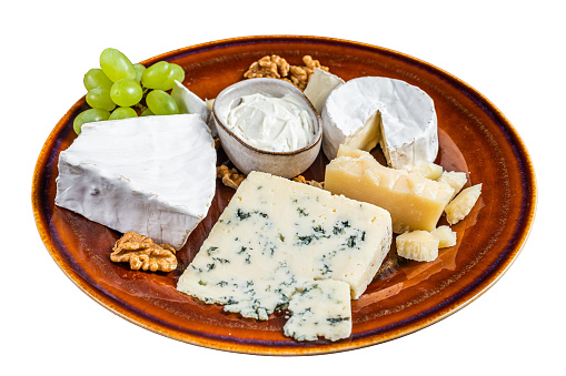 Cheese plate with Brie, Camembert, Roquefort, blue cream cheese, grape and nuts.  Isolated on white background