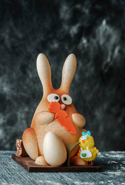 closeup of a white chocolate easter bunny as a spanish mona de pascua, a traditional confection given by godparents to godchild on easter and typically eaten on easter monday