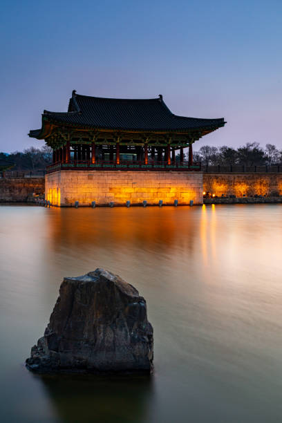Donggung Palace and Wolji Pond in Banwolseong palace at late sunset in long exposure with lights on Gyeongju, South Korea. Vertical view. stock photo