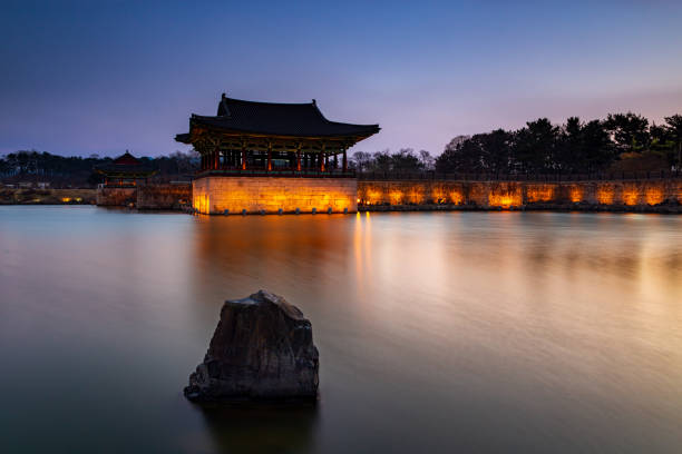 Donggung Palace and Wolji Pond in Banwolseong palace at late sunset in long exposure with lights on Gyeongju, South Korea. stock photo