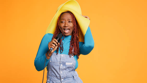 istock Joyful person singing song at microphone 1478023419