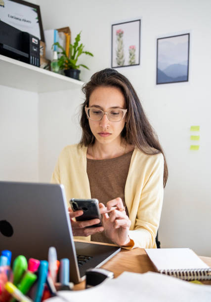 istock Woman nutritionist using mobile phone while sitting at her office desk 1478025728