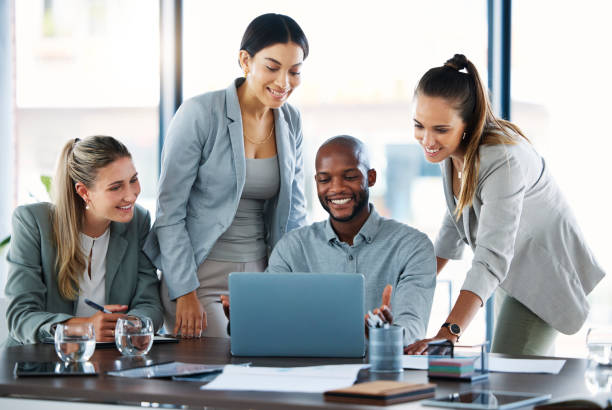 istock Teamwork, laptop and team working on a project together with research in modern corporate office. Diversity, technology and business people in collaboration on company strategy planning in workplace. 1478027159
