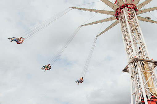 View from below of a high swing ride at a funfair in Newcastle, North East of England.