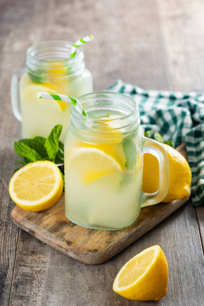 istock Lemonade drink in a jar glass on wooden table 1478032756