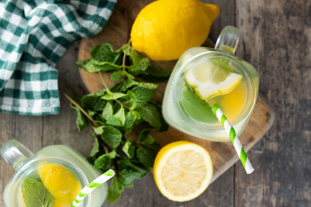 istock Lemonade drink in a jar glass and ingredients on wooden table 1478032812