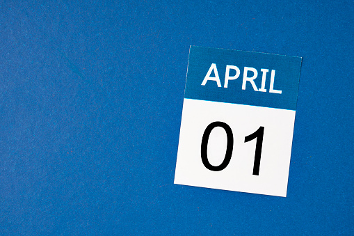 April 1st calendar sheet on dark blue background with empty space for your text or message.