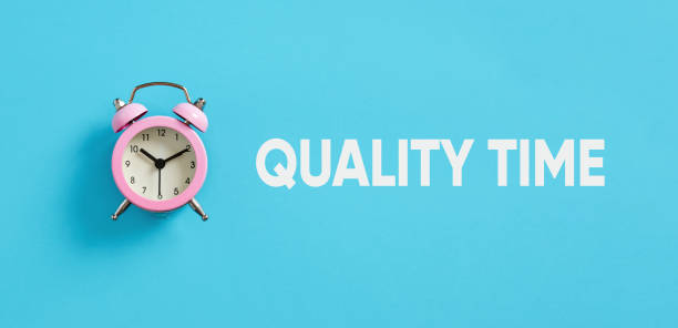 istock Spending quality time. Giving full attention to someone. Pink alarm clock on blue background with the message quality time. 1478036331