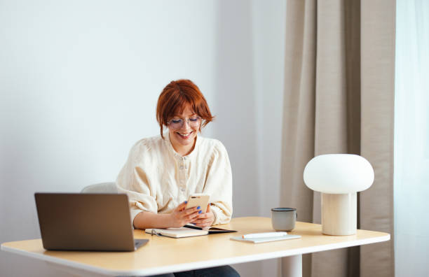 istock Happy Young Woman Using A Mobile Phone At Home 1478036356