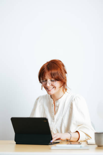 istock Smiling Female Student Using A Digital Tablet At Home 1478036424