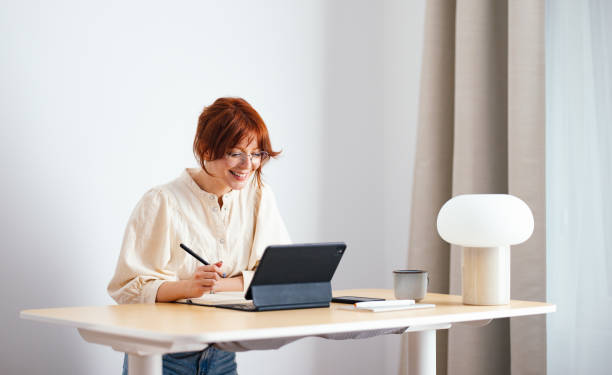 istock Happy Female Student Using A Digital Tablet At Home 1478036474