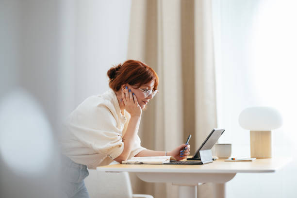 Happy Female Student Using A Digital Tablet At Home