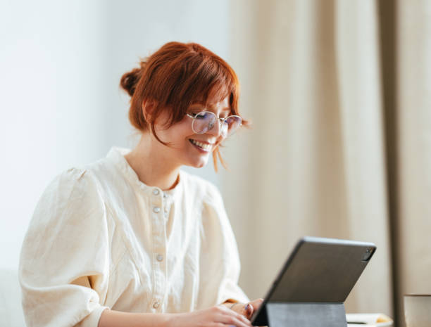 istock Happy Female Student Using A Digital Tablet At Home 1478036560