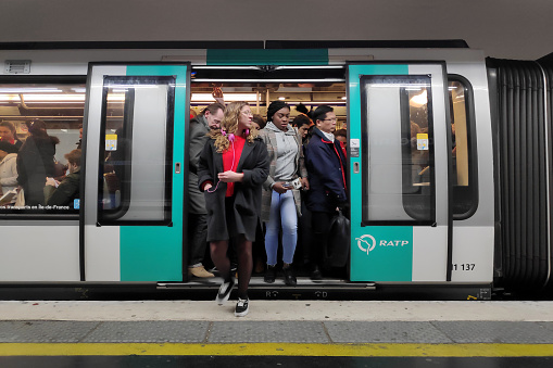 Paris, France - November 09, 2018: Commuters in a crowded metro train in the Paris metro.