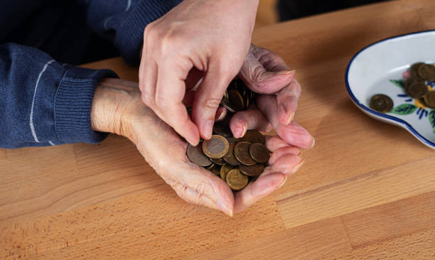 istock Men's hands full of coins 1478037124