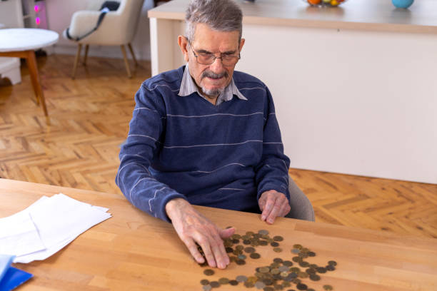 istock Senior man counting money 1478037171