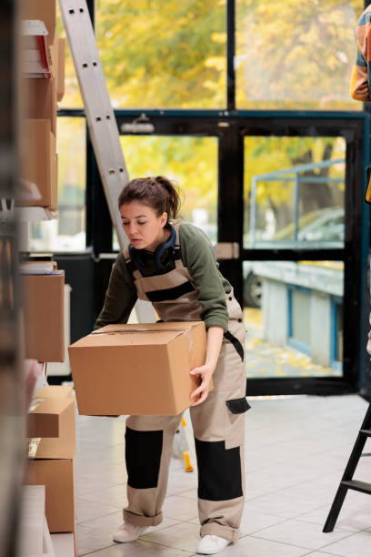 istock Storehouse employee putting cardboard boxes on shelves 1478038063