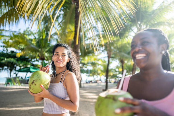 istock Friends walking in a boardwalk drinking coconut water 1478043976