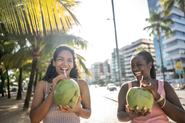 istock Friends walking in a boardwalk drinking coconut water 1478044002