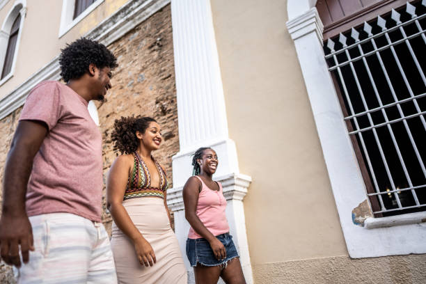 istock Friends walking and talking in the street 1478044072
