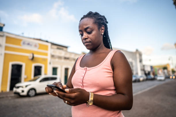 istock Mid adult woman using mobile phone at historic district 1478044089