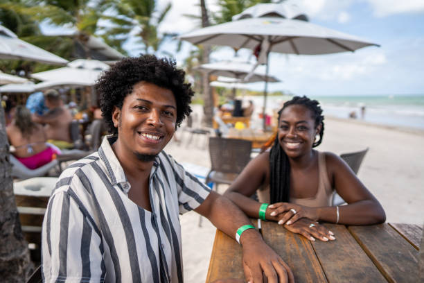 couple of a happy couple in a restaurant at the beach - couple restaurant day south america imagens e fotografias de stock