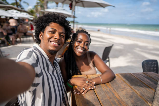 selfie of a mid adult couple in a restaurant at the beach - couple restaurant day south america imagens e fotografias de stock