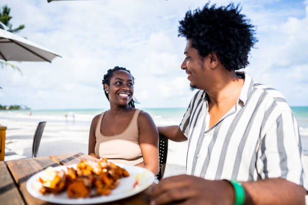 istock Happy couple in a restaurant at the beach 1478045526