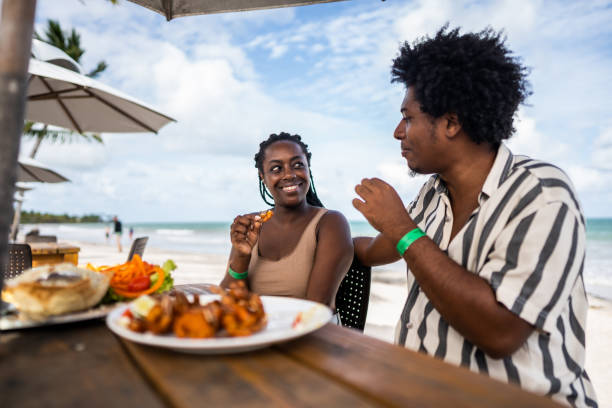 Mid adult couple eating in a restaurant at the beach