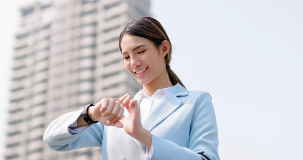 istock businessfemale look on smart watch 1478054240