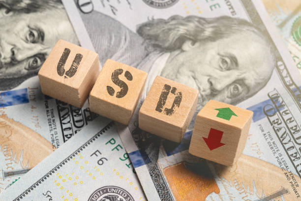 istock Wooden cubes with USD and up-down arrows over 100 usd. 1478058014