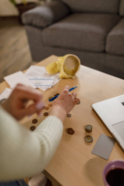 istock Young woman sorting out her savings and counting loose change 1478059233