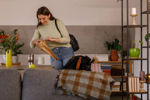 istock Young woman getting ready to go to work and packing her lunch 1478059324