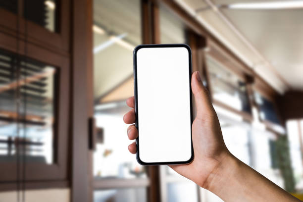 istock Man holding smartphone with blank screen, close-up of hands. Space for text. 1478059511
