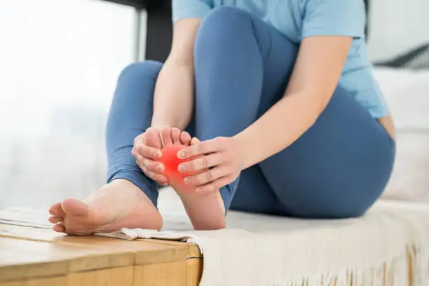 Joint diseases, hallux valgus, plantar fasciitis, heel spur, woman's leg hurts, pain in the foot, massage of female feet at home, health problems concept