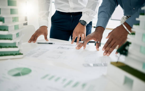 istock Paperwork, architecture and hands of team planning project together in the office with graphs, data and statistics. Teamwork, construction and people in collaboration working on building in workplace 1478065337