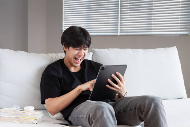 istock Overjoyed young university student man looking at smartphone screen, getting online lottery win notification or reading email with unbelievable good news, feeling motivated and joyful at living room. 1478065775