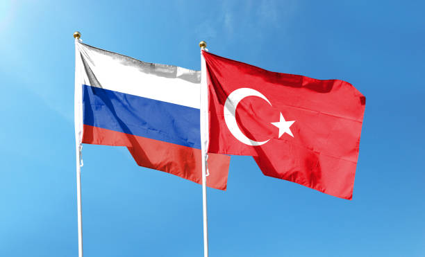 istock Russian flag and Turkish flag on cloudy sky. waving in the sky 1478071784