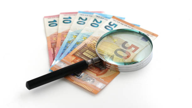 istock Euro banknotes under the magnifying glass 1478072414